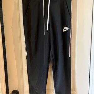 NWT. NIKE pants. Details down legs. Pockets. Drawstring at waist.